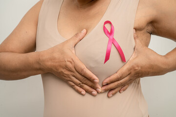 Breast cancer, pink ribbon at Asian senior lady for supporting awareness, symbol of World Breast...