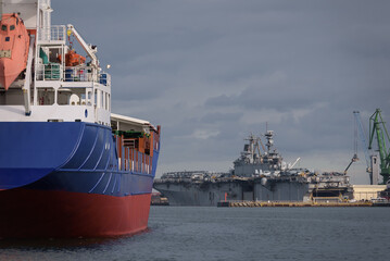 WARSHIP IN PORT - American amphibious assault ship at the wharfs and freghter