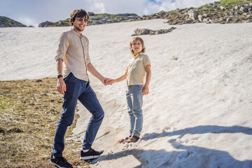 Family of tourists dad and son in Mountain lake landscape on Durmitor mountain in Montenegro beautiful Durmitor National park with lake glacier and reflecting mountain