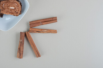Sliced sweet chocolate roll with cinnamon sticks