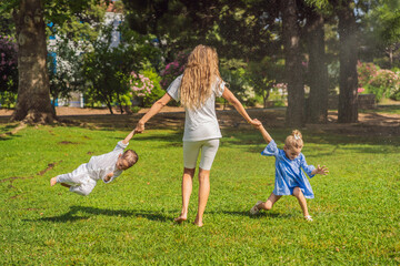 Naklejka na ściany i meble Happy family outdoors on the grass in a park, smiling faces, having fun Portrait of a disgruntled girl sitting at a cafe table