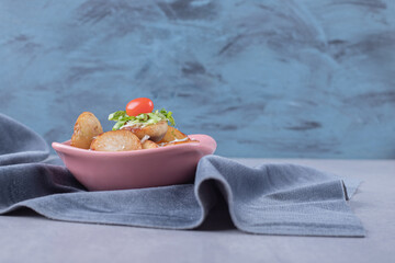 Delicious fried potatoes in pink bowl