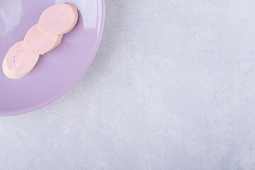 Fototapeta na wymiar Boiled homemade sausages on purple plate