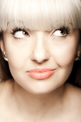 Close up portrait of a beautiful brunette girl with blond bangs fringe. Positive face expression..
