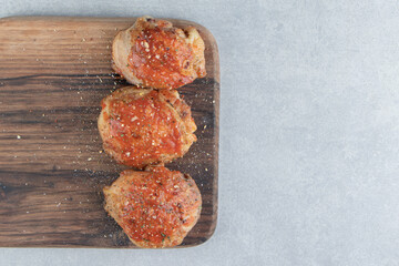 A wooden board with fried delicious chicken meat