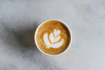 Hot cappuccino or latte art on  white marble  background.