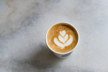 Hot cappuccino or latte art on  white marble  background.
