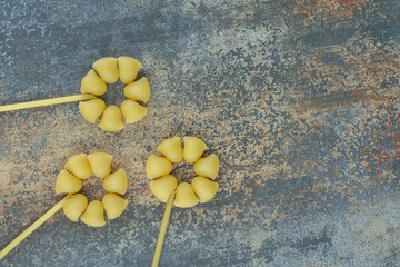 Pipe, penne and spaghetti, on the marble background