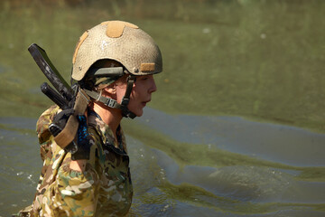 Naklejka premium Special forces soldier with weapon take part in military maneuver. War, army, technology and people concept