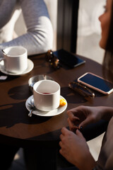 Friends in a restaurant talking smiling and drinking tea. Business colleagues having a meeting after work at a cafe bar. Abstract photo..