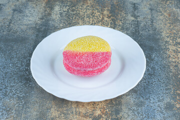 Cookie in the form of peaches on the plate, on the marble background