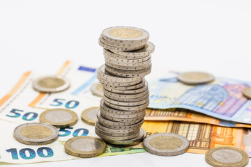 The pile of euro coins on euro notes. Euro banknotes and coins