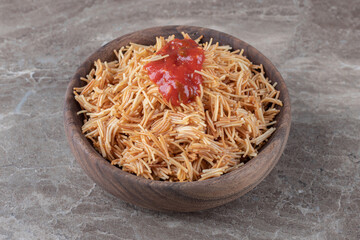 Vermicelli pasta with tomato sauce in the bowl , on the marble background