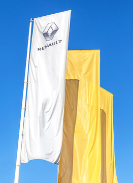 Dealership flags of Renault against the blue sky