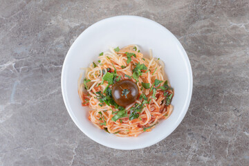 Tasty appetizing classic Italian spaghetti pasta with tomato , on the marble background