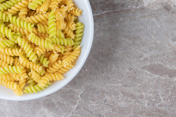 A bowl of mixed pasta , on the marble background