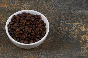 Aromatic coffee beans in white bowl