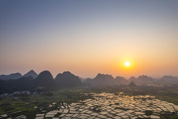 Aerial photo of the sunrise scene of Guilin's landscape Huixian glass field