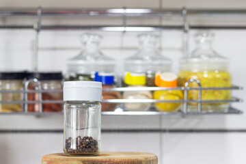 pot with pepper close-up on the background of the kitchen shelf with seasonings, kitchen and cooking with spices