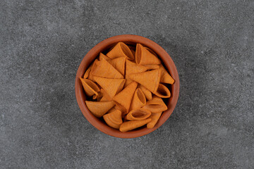 Delicious crunchy chips in ceramic bowl