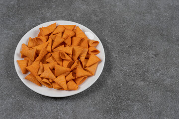 Triangle shaped chips on white plate