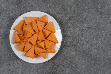 Triangle shaped chips on white plate