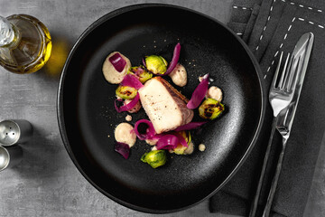 Pacific Amberjack fillet with vegetables and sauce.
