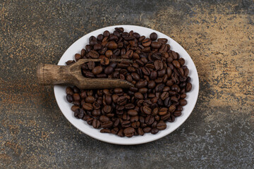 Whole black pepper spices on white plate
