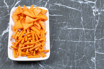 Assortment of spiced chips on white plate