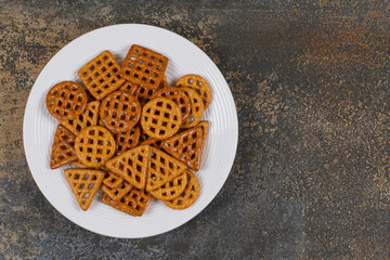 Salted hard crackers on white plate