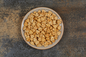 Bunch of heart shaped crackers on ceramic plate