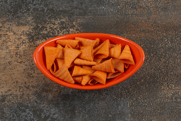Yummy triangle chips in orange bowl