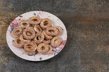Tasty hard crackers with salt on colorful plate