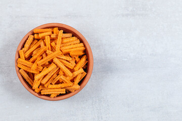 Spicy stick chips in ceramic bowl