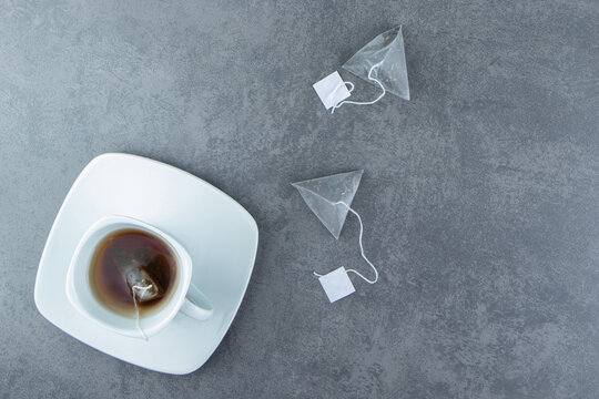 A white cup of hot tea with teabags