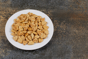 Bunch of heart shaped crackers on white plate