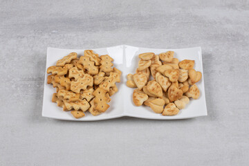 Two different kinds of crackers on white plate
