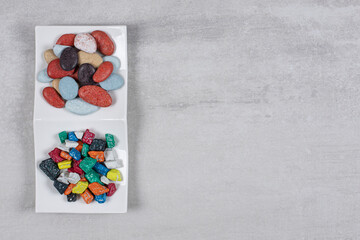 Two types of stone candies on white plate