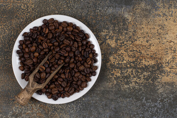 Whole black pepper spices on white plate