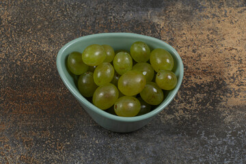 Pile of green grapes in blue bowl