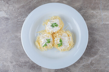 Spaghetti, yogurt and green vegetable on the plate , on the marble background