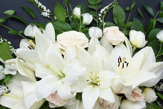 White delicate lily flowers composition, condolence flower background card, funeral concept image, selective focus, shallow DOF	