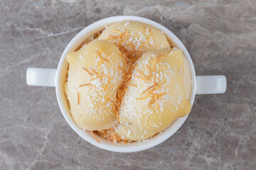 Spicy tasty pasta in bowl , on the marble background