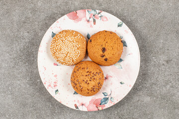 Top view of three homemade sweet cookies on white plate