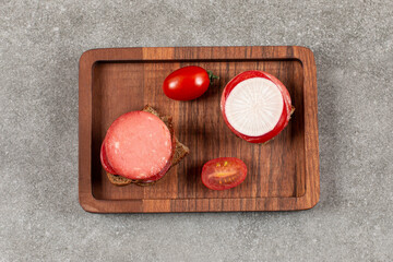 Top up view of homemade sandwich and vegetable on wooden plate