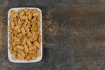 Set of salty crackers on white square plate