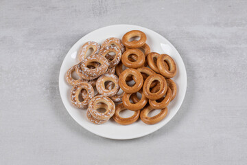 Two types of salted pretzel rings on white plate