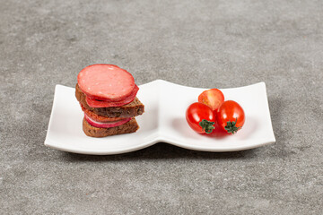 Homemade sandwich and tomato on white plate