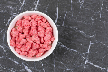 Pink cereal flakes on white plate
