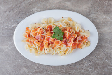 Farfalle pasta with bolognese on the plate , on the marble background